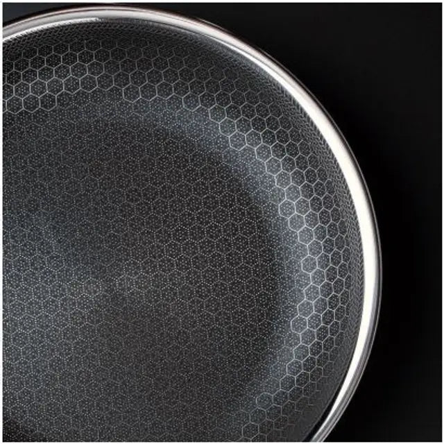 Close-up of a speaker grille with a hexagonal pattern design.